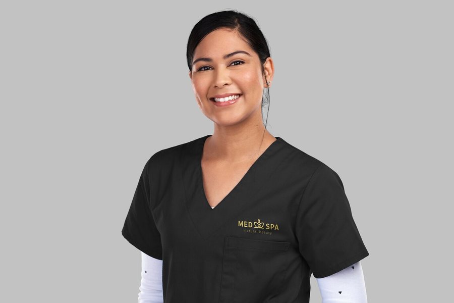 Med spa team member wearing branded scrubs